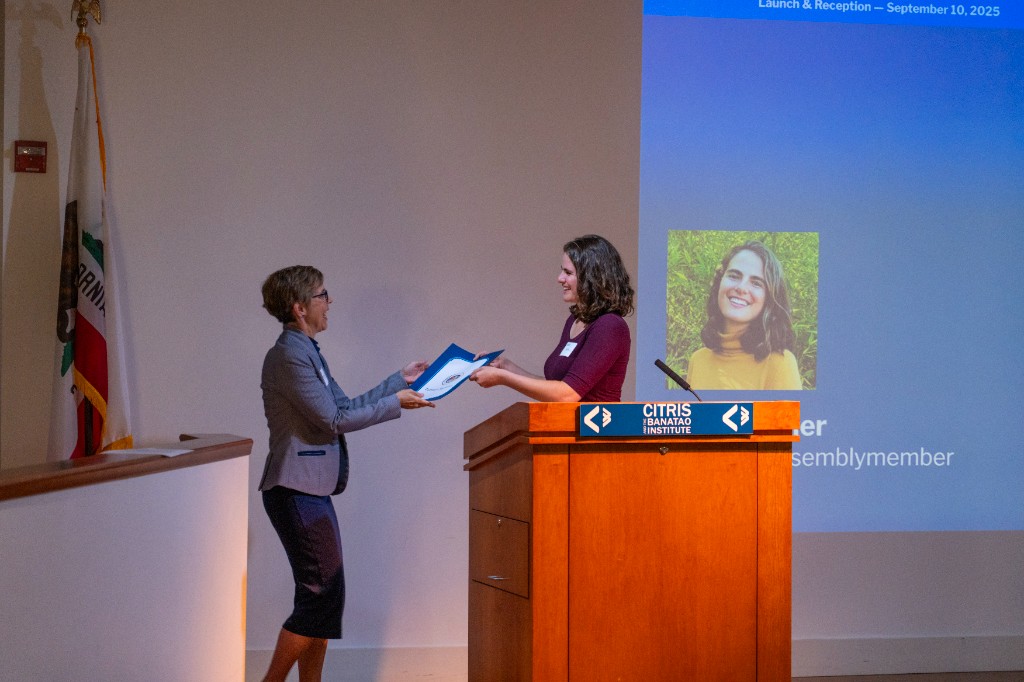 Stella Grysler presents the Certificate of Recognition to Camille Crittenden